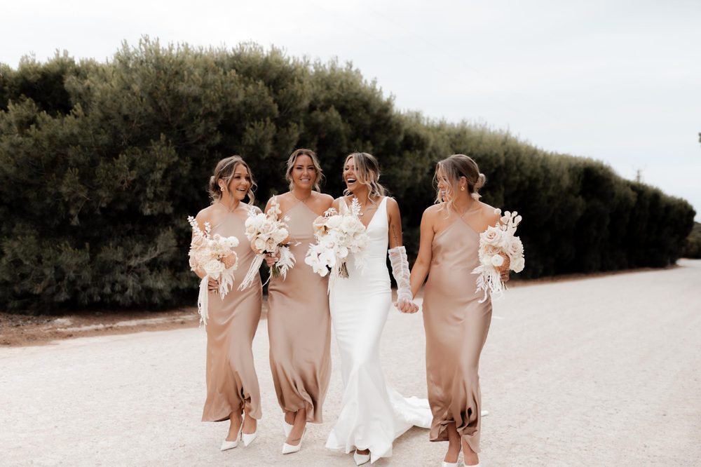 Bridal party walking a country road