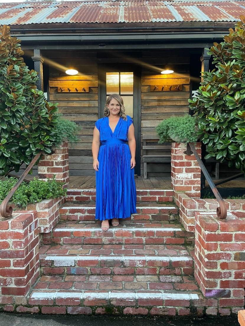 Blue formal gown on stone steps at dusk