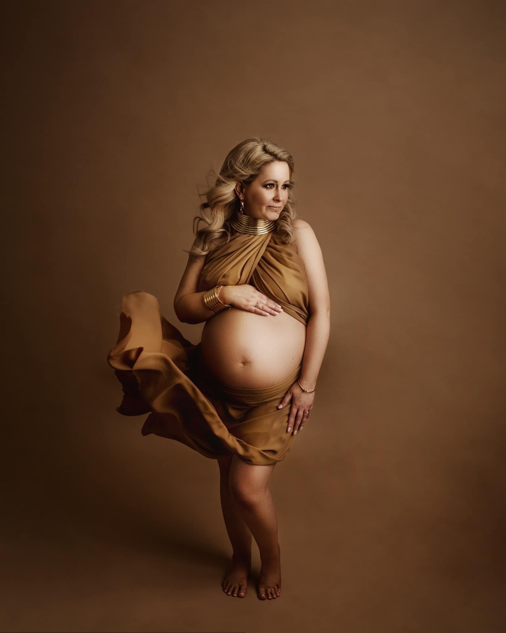 Maternity photoshoot, editorial gold styling, glowing tan