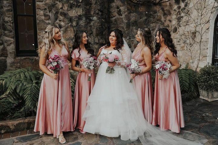 Bridesmaids in blush pink gowns